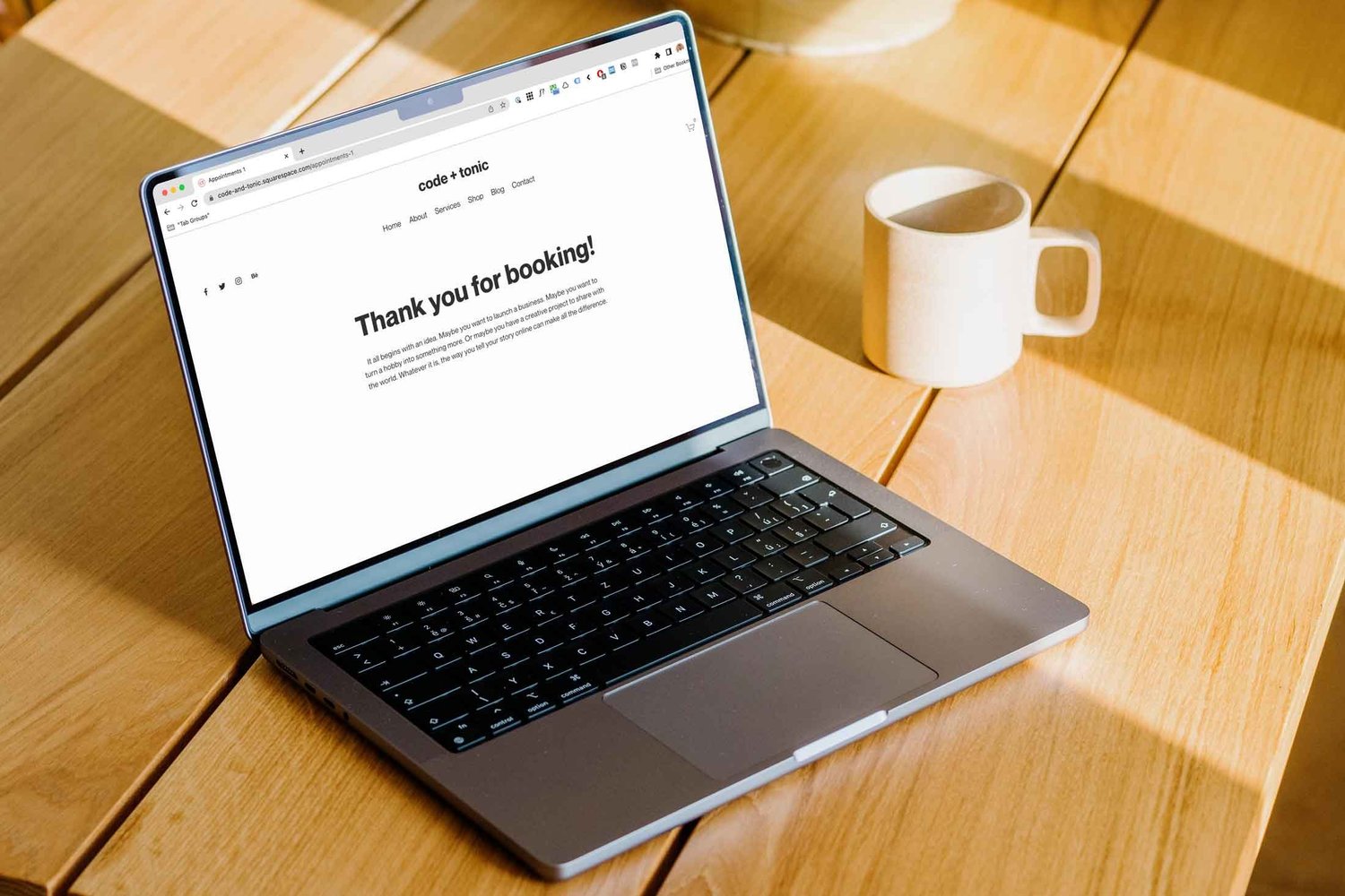 Laptop mockup beside a coffee mug and fruit basket — Acuity Scheduling redirect article